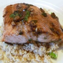 A salmon fillet on a bed of quinoa.