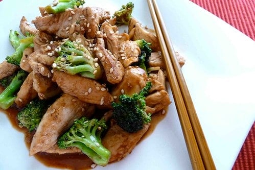 Chicken and broccoli stir on a white plate.