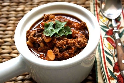 Turkey chili with beans in a white crock.