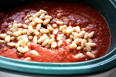 White beans, pork and tomato saucepan in a crockpot.
