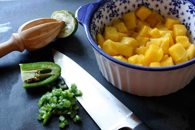 Mango in a bowl, with chopped jalapeño on the side.