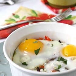 Baked eggs and vegetables in a small baking dish.