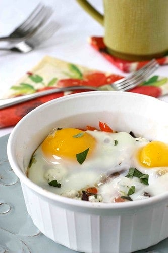 Baked eggs and vegetables in a small baking dish.