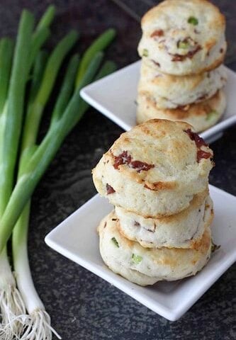 Cream Biscuits with Prosciutto piled on two with plates.