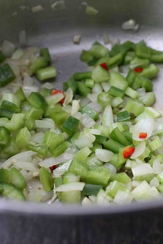 Chopped onion and green pepper in a skillet.