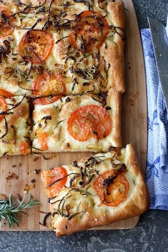 This focaccia recipe, topped with caramelized onions and tomatoes, is inspired by a trip to Italy and a meeting with a kind-hearted Italian grandmother.