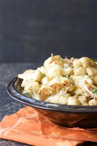 Roasted cauliflower goes from boring to crave-worthy when tossed with Indian spices. Serve this alongside curry or Sunday's roast chicken. It's that versatile!