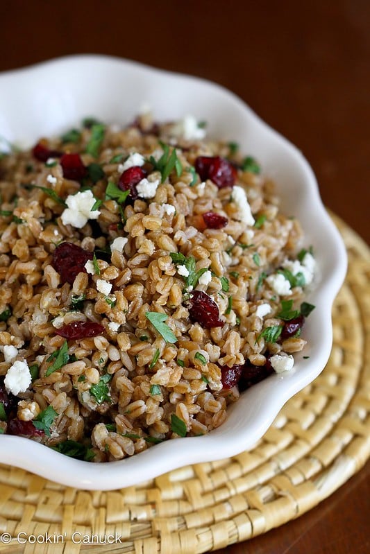 Farro salad with goat cheese and cranberries in a white bowl.