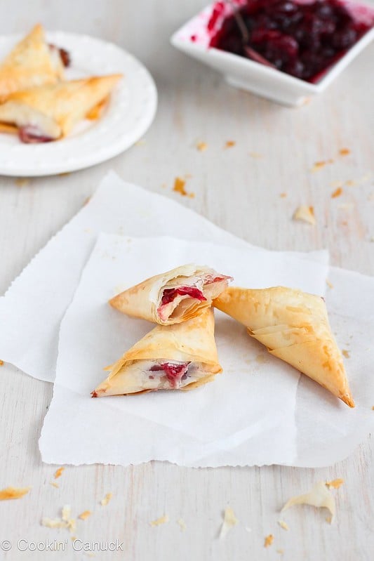 Only 3 ingredients needed for these amazing Brie and Cranberry Phyllo Turnovers. Irresistibly flaky and perfectly cheesy! 58 calories and 2 Weight Watchers SmartPoints