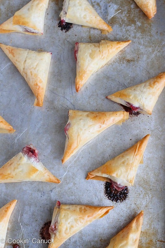 Only 3 ingredients needed for these amazing Brie and Cranberry Phyllo Turnovers. Irresistibly flaky and perfectly cheesy! 58 calories and 2 Weight Watchers SmartPoints