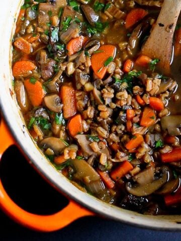 The flavors in this vegan Hearty Mushroom, Farro & Ginger Soup are not to be missed! 247 calories and 4 Weight Watchers Freestyle SP #vegan