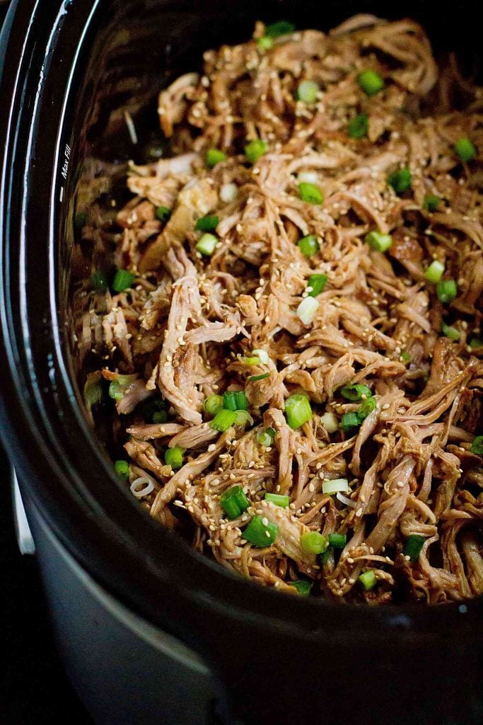 This Slow Cooker Teriyaki Pulled Pork is fantastic over rice, in tacos with slaw or on hamburger buns! 240 calories and 7 Weight Watchers SmartPoints