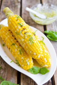 Sweet corn on the cob is made even better with a dollop of pesto butter. The perfect summertime side dish recipe! 118 calories and 2 Weight Watchers Freestyle SP