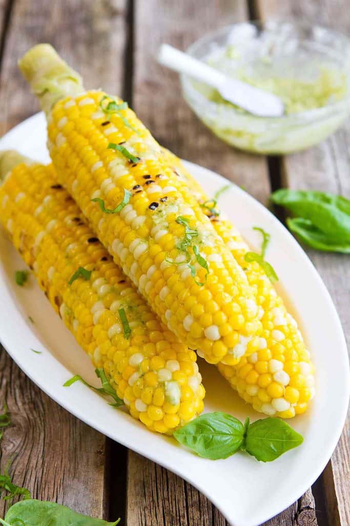 Sweet corn on the cob is made even better with a dollop of pesto butter. The perfect summertime side dish recipe! 118 calories and 2 Weight Watchers Freestyle SP