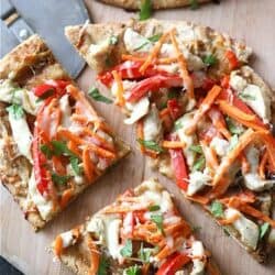 This healthy Thai Chicken Naan Pizza is a family favorite for a reason. The peanut sauce, tender naan and vegetables make this irresistible! #pizza #thaichicken #naan
