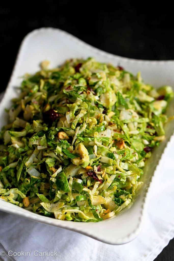 Shredded Brussels sprouts are an easy and colorful side dish for Thanksgiving. Tons of flavor from the pistachios, dried cranberries and Parmesan! 83 calories and 3 Weight Watchers Freestyle SP #brusselssprouts #sidedish #cleaneating