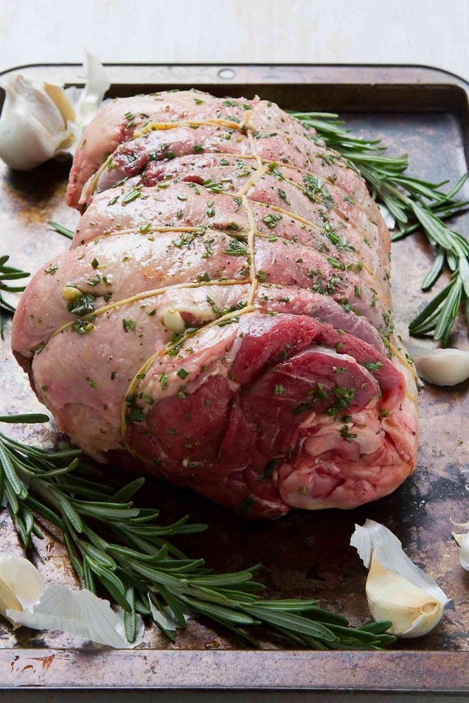 Boneless leg of lamb, tied and seasoned with rosemary, garlic, olive oil, salt and pepper.