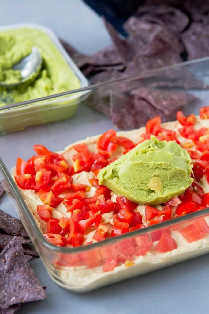 Putting together a healthy 7-layer dip.
