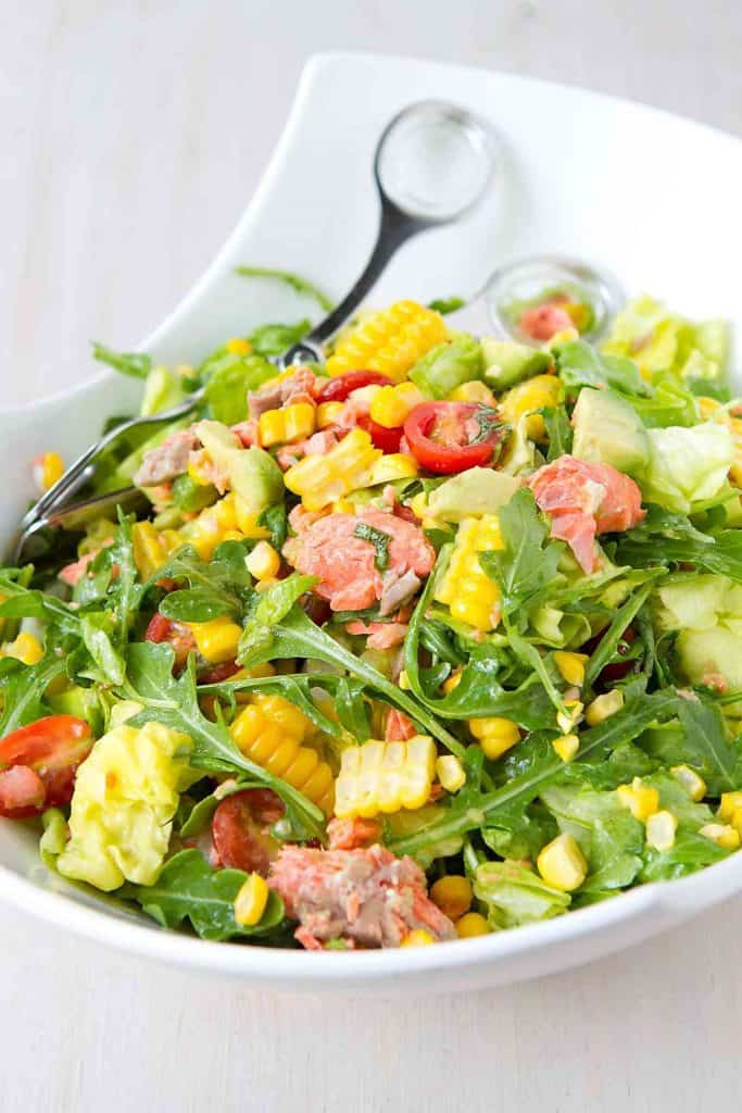 Dinner salads are a fantastic way to fill your plate with veggies and lean protein. This Summertime Salmon Chopped Salad recipe has all of that, plus tons of flavor! 349 calories and 6 Weight Watchers Freestyle SP #dinner #salad #salmon #cleaneating