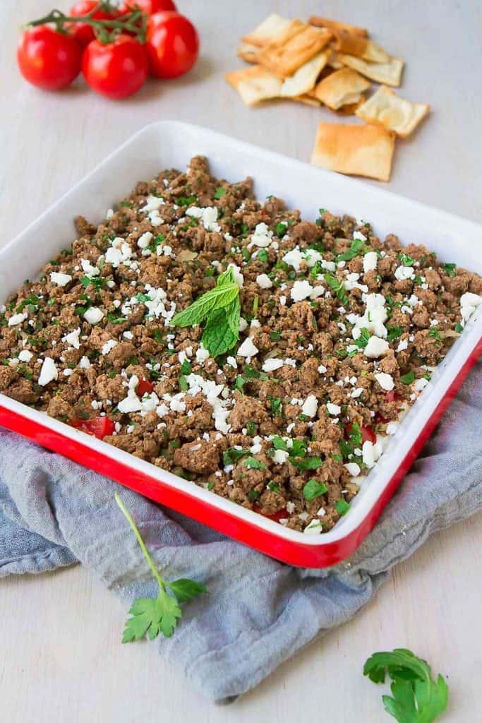 Flavor alert! From the spiced ground beef to the hummus yogurt mixture and fresh veggies, this Beef Kofta Dip recipe will keep you dipping all day long. 146 calories and 3 Weight Watchers Freestyle SP #dip #appetizer #recipe