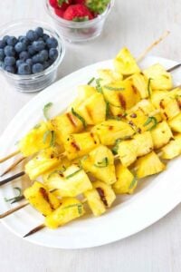 Grilled pineapple is a fantastic way to curb your sweet tooth without breaking the calorie bank. Serve these honey lime-brushed kabobs with ice cream or grilled shrimp and chicken. 72 calories and 2 Weight Watchers Freestyle SP #pineapple #grilled #fruit #recipe