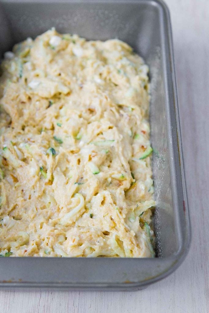 Savory zucchini bread batter in a loaf pan, ready to bake.