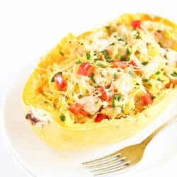 Chicken stuffed spaghetti squash is taken to a whole new level in this easy recipe. It is stuffed with veggies and flavored with pesto for a healthy dinner. 230 calories and 5 Weight Watchers Freestyles SP #spaghettisquash #chickenrecipe #healthydinner