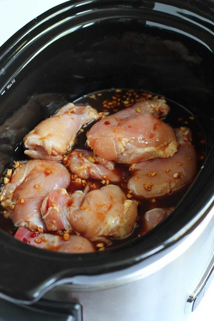 Chicken thighs in slow cooker with soy sauce and hoisin sauce.