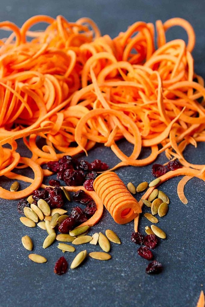 Spiralized sweet potato noodles with dried cranberries and pepitas.