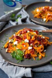 Sweet potato noodles are spruced up with crispy prosciutto, dried cranberries and creamy goat cheese. The perfect autumn side dish! 167 calories and 6 Weight Watchers Freestyle SP #sweetpotato #recipe