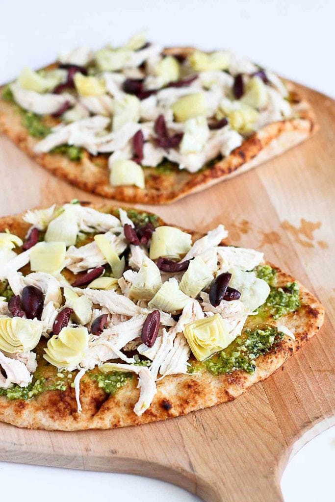 Whole wheat naan bread, topped with pesto, chicken, olives and artichokes.