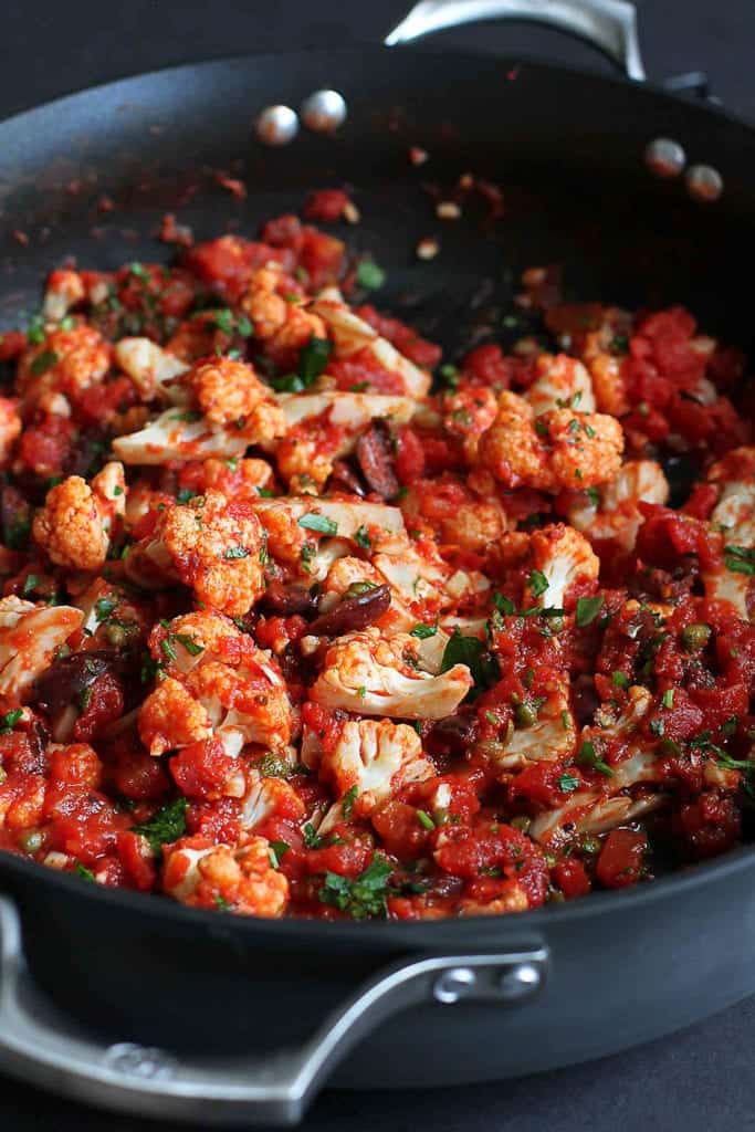 Cauliflower and tomato sauce in a large skillet.