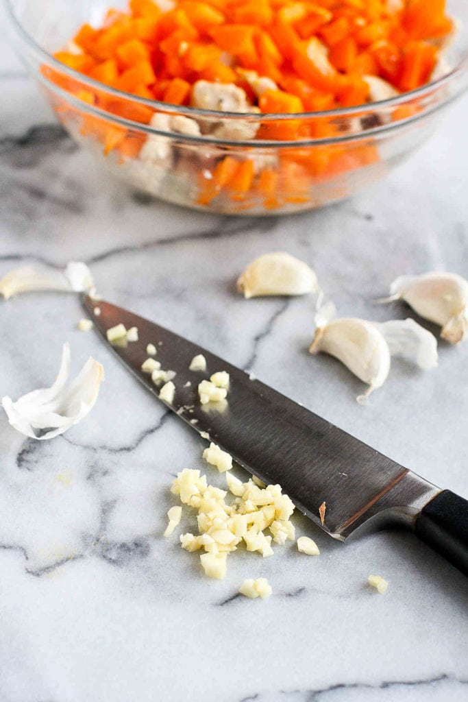Chopped garlic on a marble surface.