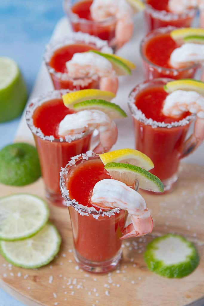 An appetizer with a kick! Spice up the party with these Bloody Mary Shrimp Shooters! A fun little twist on shrimp cocktail for your holiday or cocktail parties. 65 calories and 2 Weight Watchers Freestyle SP #appetizer #bloodymary #shrimprecipes