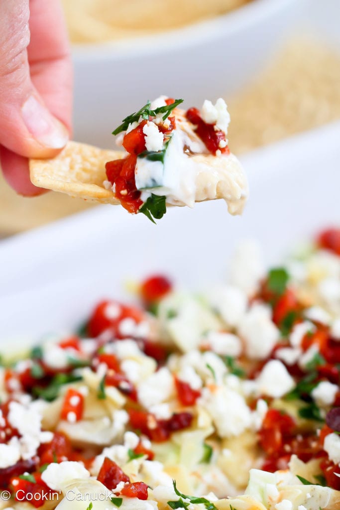 This Mediterranean 7-Layer Dip Recipe is a fresh and healthy take on a classic appetizer. It will be a hit at your Super Bowl party (or any other get-together)! 49 calories and 1 Weight Watchers Freestyle SP #7layerdip #healthydip #appetizerrecipe
