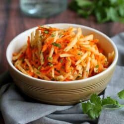 This refreshing jicama and carrot slaw recipe is fantastic served as a side dish or pile high on fish tacos. It's perfect for your Cinco de Mayo party, too! 54 calories and 1 Weight Watchers SP #slaw #jicama #weightwatchers #cleaneating