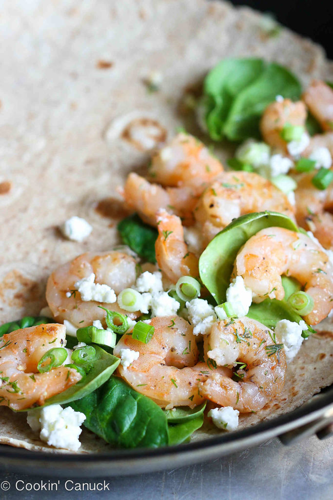 Shrimp, spinach and feta in a tortilla, in a skillet.