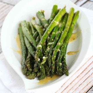 In this roasted asparagus recipe, the fresh springtime vegetable is tossed with olive and roasted until tender, then drizzled with a simple Dijon vinaigrette. 66 calories and 1 Weight Watchers Freestyle SP #weightwatchers #asparagus
