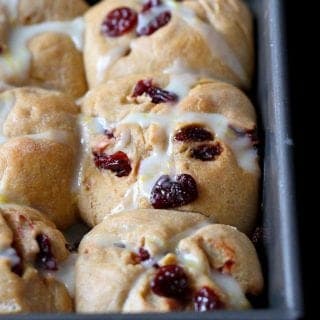 This healthy whole wheat hot cross bun recipe is perfect for Easter breakfast. The tart cherries and lemon glaze add a sweet tang to the tender buns. #hotcrossbuns #Easter #recipe
