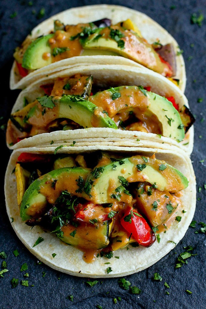 So much flavor in these vegan tacos! A simple Thai peanut sauce, along with grilled vegetables make a fantastic meal. 238 calories and 6 Weight Watchers Freestyle SP #vegetarian #vegetables #recipe