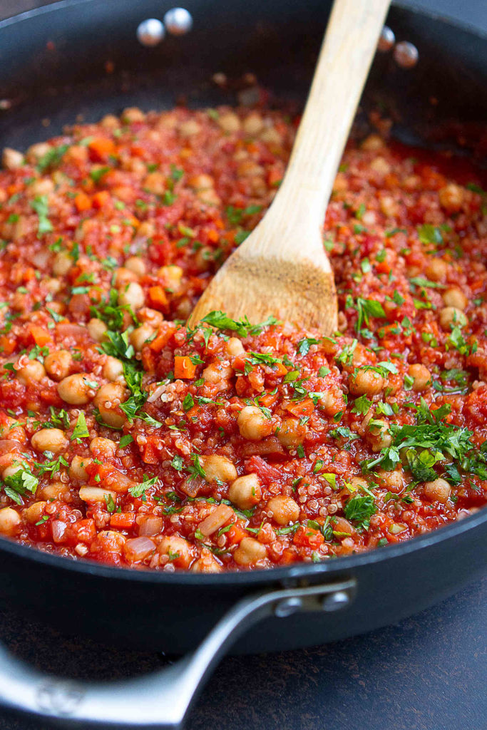 Tomato sauce, chickpea and quinoa mixture simmering in a large nonstick skillet.