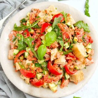 Classic panzanella salad transforms into a dinner salad with the addition of perfectly cooked salmon. Tons of veggies and even more flavor make this a summertime favorite! 377 calories and 5 Weight Watchers Freestyle SP #salmon #panzanella #healthyrecipes #weightwatchers