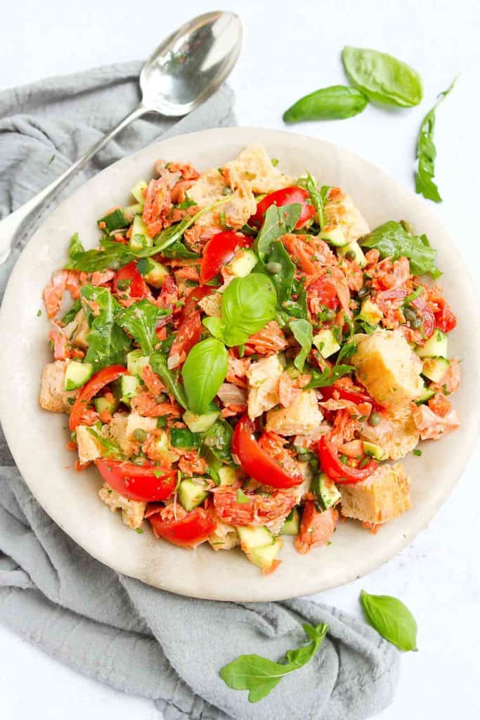 Classic panzanella salad transforms into a dinner salad with the addition of perfectly cooked salmon. Tons of veggies and even more flavor make this a summertime favorite! 377 calories and 5 Weight Watchers Freestyle SP #salmon #panzanella #healthyrecipes #weightwatchers