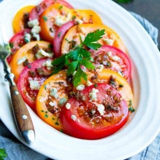 Summertime tomatoes are fantastic on their own, but this Heirloom Tomato Salad is taken to the next level with a light vinaigrette and blue cheese crumbles. 86 calories and 3 Weight Watchers Freestyle SP #tomato #saladrecipes #healthy