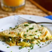 This veggie omelette packs in a ton of flavor and is ready in less than 20 minutes. It's perfect for brunch or a quick, healthy dinner! 163 calories and 1 Weight Watchers Freestyle SP #vegetarian #eggs #omelet