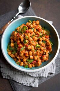 This Crockpot Spiced Chickpea Stew (Vegan) is one of the first meatless meals I fell in love with. So much flavor and your kitchen will smell amazing! 295 calories and 1 Weight Watchers SP | Vegetarian | Slow Cooker | Mediterranean | Easy | Dinner | Healthy | Spinach #cookincanuck #veganrecipes #crockpotrecipes