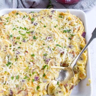 This loaded mashed potato casserole with bacon and caramelized onions just might steal the show on feast day! It’s fantastic for as a Sunday dinner side dish, too. 141 calories and 4 Weight Watchers SP | Thanksgiving | Holidays | Make Ahead | Side Dishes | With Cream Cheese | Easy | Without Sour Cream | For A Crowd #thanksgivingrecipes #mashedpotatocasserole #mashedpotatoes #thanksgivingrecipes #Creamerpotatoes