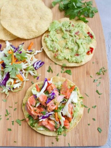 Another 20 minute meal! My family LOVED these Salmon Tostadas with Guacamole, and they couldn't be easier to make. 255 calories and 5 Weight Watchers SP | Mexicanas | Healthy | Shells | Easy | Fish | How To Make #salmontostadas #fishtostadas #smartpoints #weightwatchers #salmonrecipes