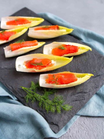 Looking for an easy holiday appetizer? A batch of Smoked Salmon Endive Boats can be made in about 15 minutes. Then watch them disappear from the plate in seconds! 76 calories and 1 Weight Watchers SP | Appetizers | Vegetarian | Healthy | Parties | Finger Food | New Year’s Eve | Stuffed | Hors D’Oeuvres | Simple #appetizerrecipes #smokedsalmon #newyearseve #fingerfood #horsdoeuvres #smartpoints #weightwatchers