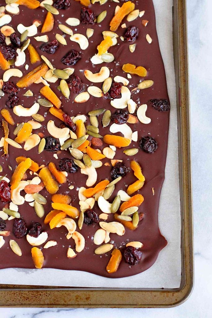 Chocolate bark is fantastic for serving at parties or gift giving. Make it with raw nuts, seeds and dried fruit for a healthy spin. 93 calories and 4 Weight Watchers SP | Desserts | Food Gifts | Homemade | Christmas | Holidays | Neighbor | Recipes | Dark | How To Make | Easy #foodgifts #healthydesserts #trailmix #smartpoints #weightwatchers
